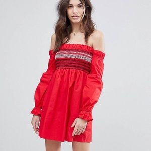 Red smocked dress with white and blue detail